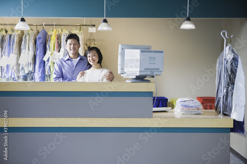 Photo: Asian male and female drycleaners Asian male and female drycleaners