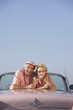 Senior couple in a pink convertible