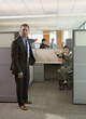 Business people pointing at each other in office cubicles