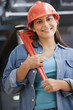 Hispanic female construction worker holding a wrench