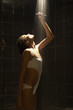 Woman in bathing suit rinsing in shower