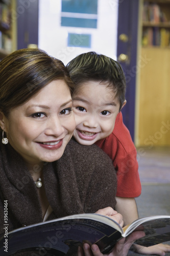 Photo: Close up of mother and young son smiling Close up of mother and young son smiling