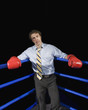 Businessman in corner of boxing ring with black eye