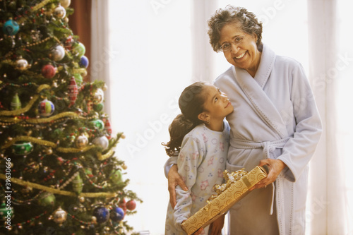 Photo: Hispanic grandmother and granddaughter on Christmas morning Hispanic grandmother and granddaughter on Christmas morning
