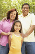 Hispanic family smiling outdoors