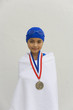 Hispanic girl wrapped in towel with swimming metal
