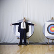 Businessman standing in front of bulls eye