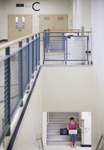 Photo: Female student with laptop on stairs Female student with laptop on stairs
