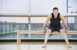 Man in athletic gear sitting in dance studio