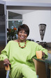 Middle-aged African woman smiling with coffee