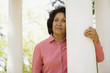 Senior woman leaning on column outdoors
