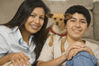 Hispanic mother and son with small dog