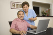 Senior Hispanic couple with credit card and laptop