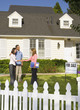 Couple shaking hands with real estate agent