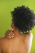 Rear view of African woman with hand rubbing neck