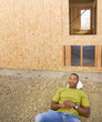 Male construction worker sleeping at construction site