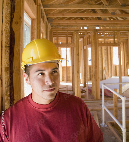 Photo: Hispanic male construction worker inside construction site Hispanic male construction worker inside construction site