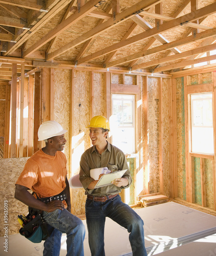 Photo: Two construction workers inside construction site Two construction workers inside construction site