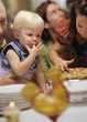 Photo: Young girl and toddler sticking fingers in pie Young girl and toddler sticking fingers in pie