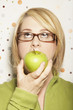 Young woman eating apple