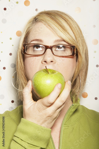 Photo: Young woman eating apple Young woman eating apple