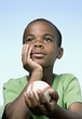 African boy holding baseball