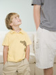 Young boy smiling up at father