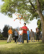Hispanic girl being blindfolded next to pinata