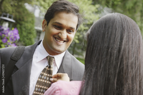 Photo: Indian woman adjusting husband's necktie Indian woman adjusting husband's necktie