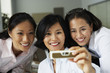 Asian businesswomen taking own photograph