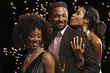 African man dancing with two women