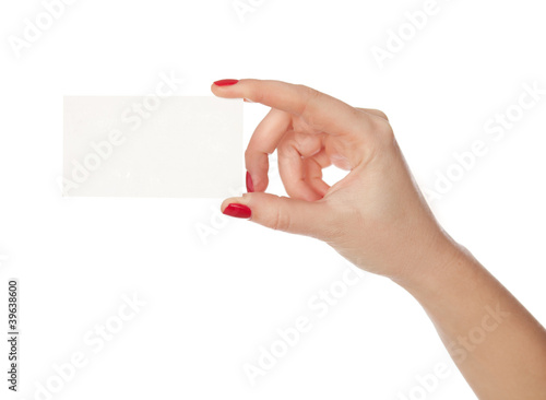 Photo: Female hand holding a blank paper. isolated in white Female hand holding a blank paper. isolated in white