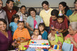 Large Hispanic family celebrating birthday