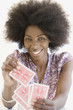 African woman holding playing cards