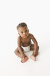 High angle view of African baby sitting on floor