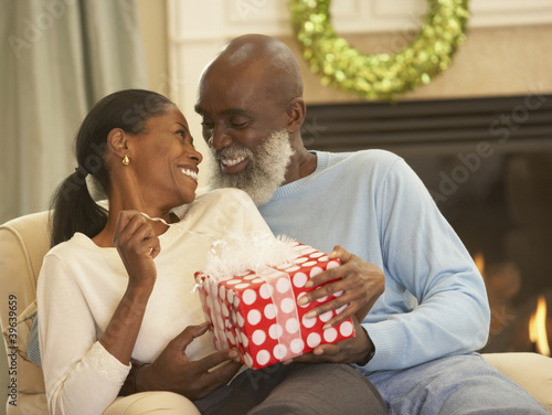Photo: Senior African man giving gift to wife Senior African man giving gift to wife