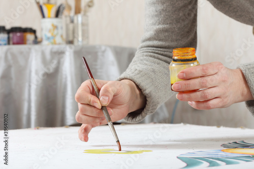 Photo: painting on fabric, women's hands at work painting on fabric, women's hands at work
