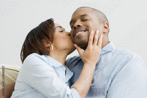 Photo: African woman kissing husband on cheek African woman kissing husband on cheek