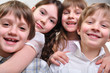 happy group of children hugging together