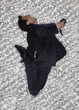 Hispanic businessman jumping and listening to music