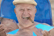 Senior man smoking cigar and sunbathing