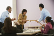 Businesspeople playing tug of war