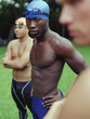 Multi-ethnic male swimmers outdoors