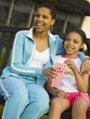 African mother and daughter eating popcorn