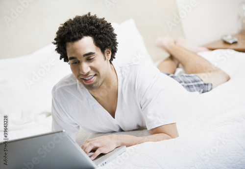 Photo: African man typing on laptop African man typing on laptop