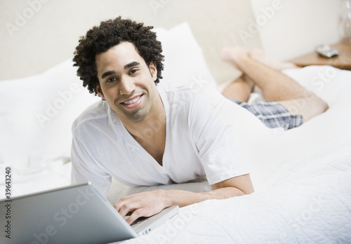 Photo: African man typing on laptop African man typing on laptop