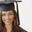 Indian woman wearing graduation cap and gown