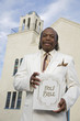 Senior African American man in front of church