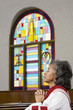 African American female Reverend praying