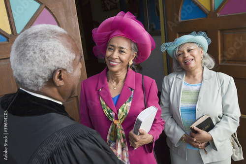 Photo: Senior African American women talking to Reverend Senior African American women talking to Reverend